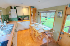 Carriage-2-Kitchen-leading-to-twin-table-set-in-springtime